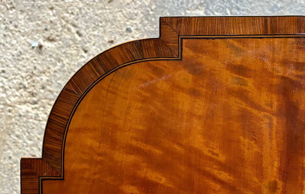 A lovely George III satinwood Pembroke table, the shaped drop leaf top with elegant crossbanding above a single end drawer with a dummy drawer on the opposing side, raised on gently tapering square legs with delicate inlay detailing over brass castors, with some gentle surface patina to the top as is commensurate with age and use, in very good condition