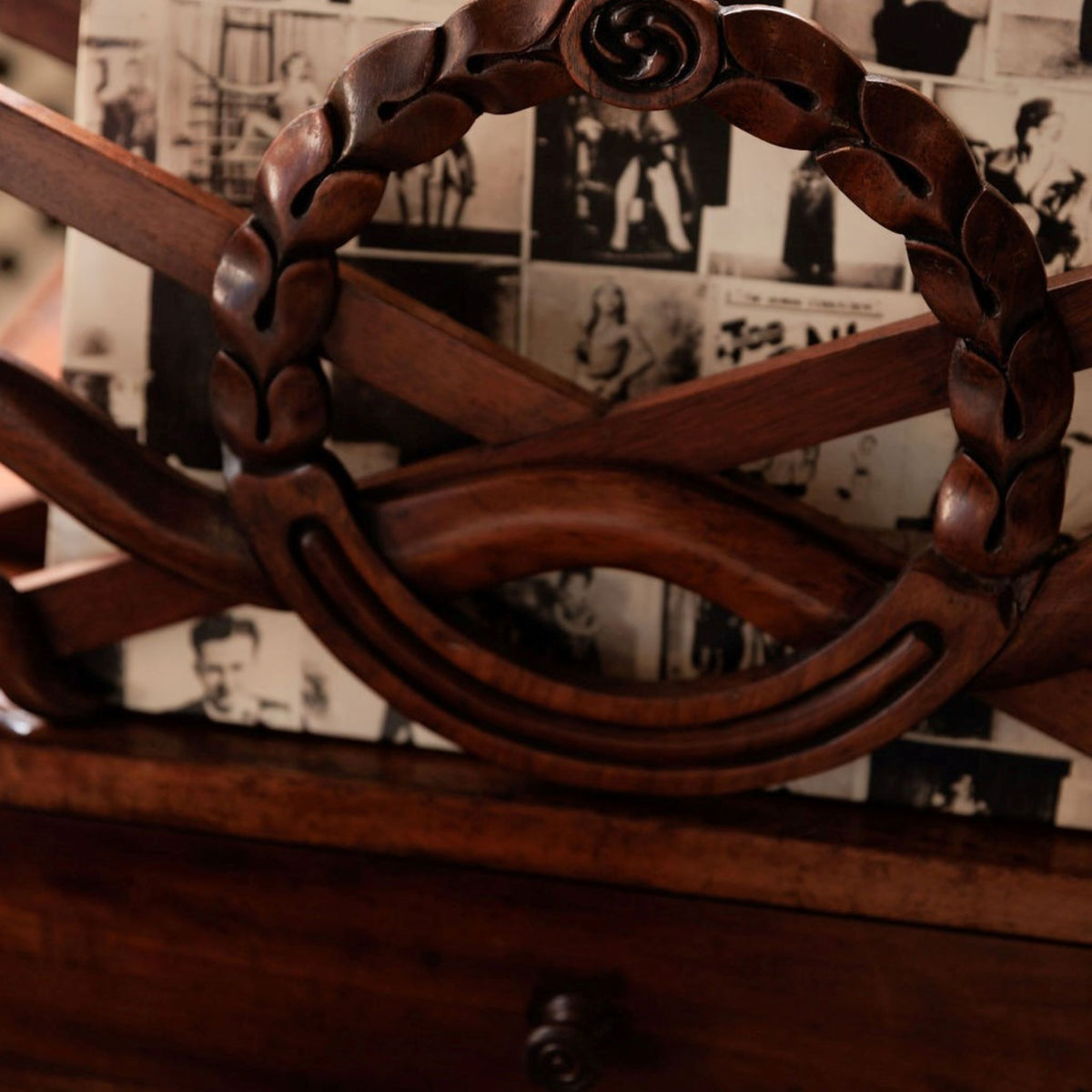 A beautiful mahogany canterbury, circa 1820, with five cross framed dividers incorporating a laurel wreath motif. With a single drawer below and raised on turned legs with original castors. In very good condition.