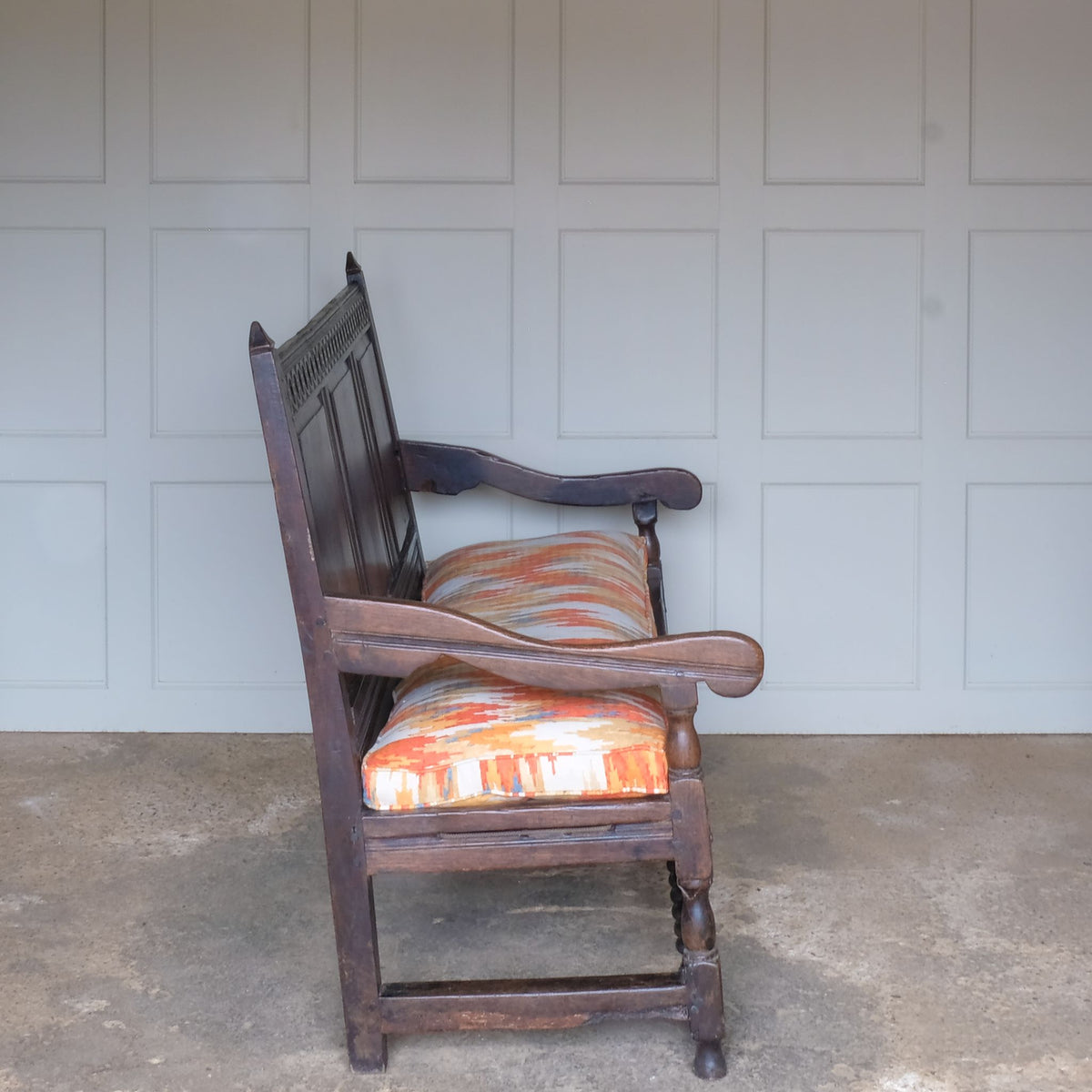 A side view of Vintage 18th Century Oak Settle with Upholstered Cushion - Summerfield & Scott