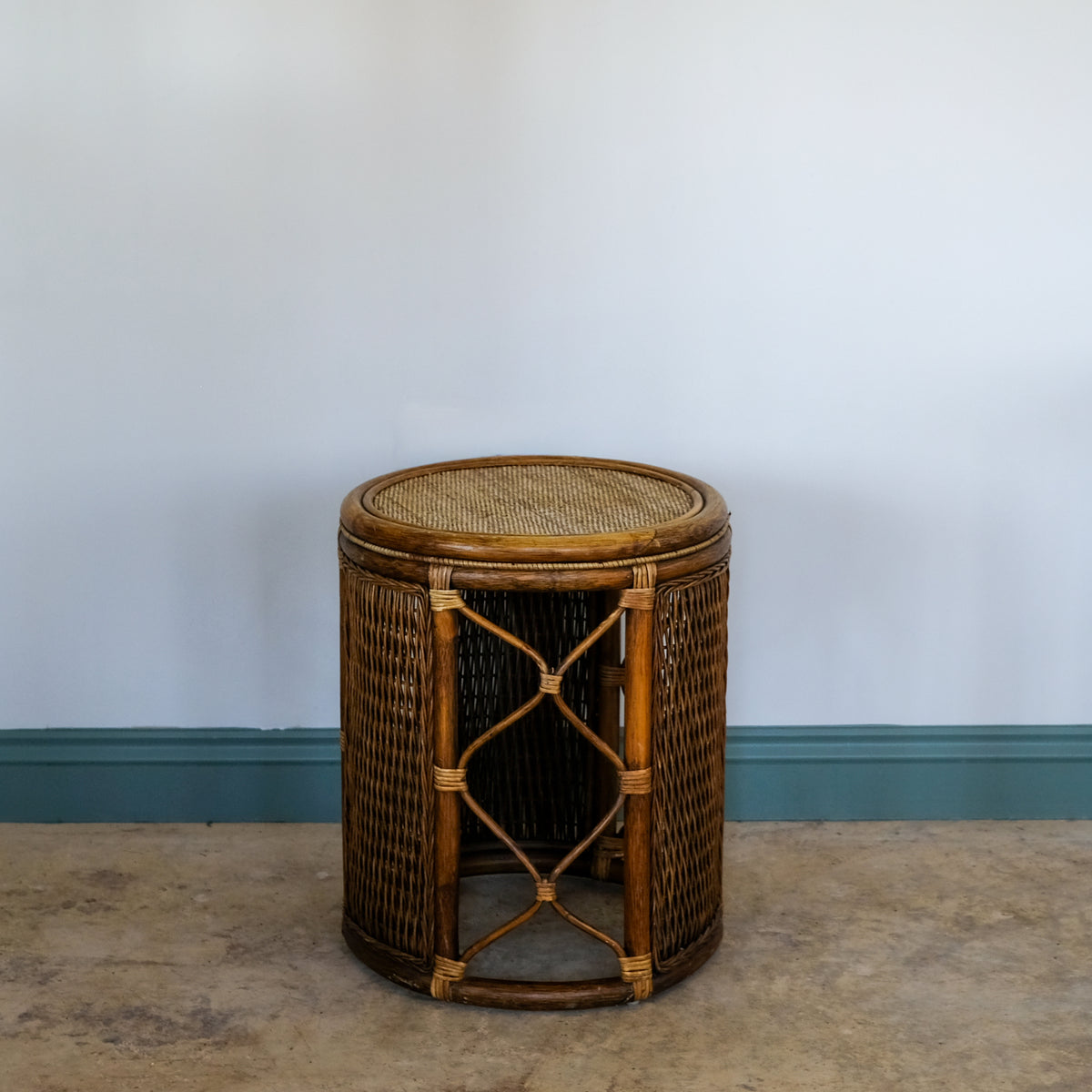 Wicker side table against a plain wall