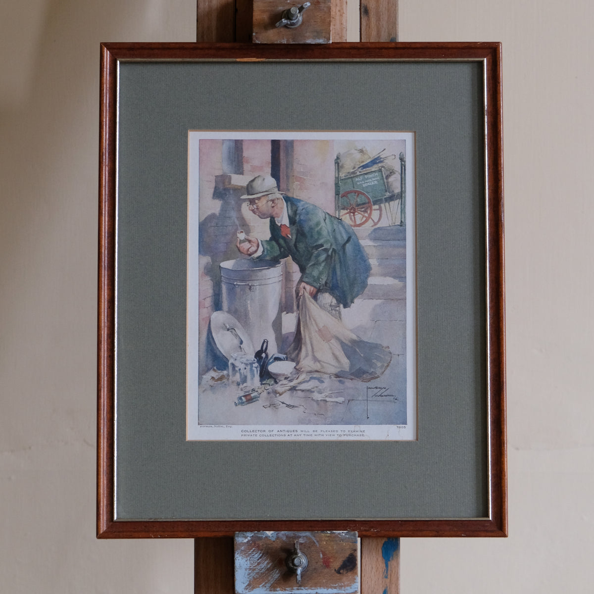 Framed artwork of a man with a dog on a street scene